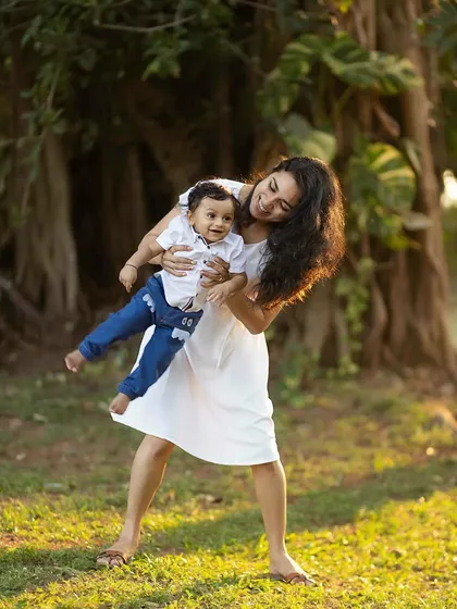 A mother playfully holding her son, both sharing a beautiful smile. These dynamic shots add so much life to a gallery.