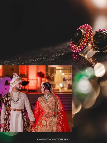 A creative shot of the couple's wedding rings, with a portrait of them in their wedding attire in the background.