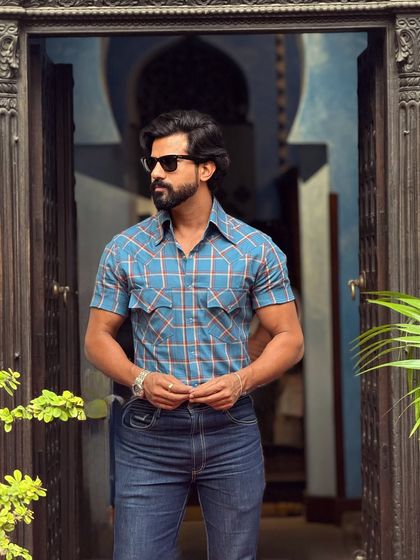 Step out in style with our chic half-sleeves shirt in a blue check pattern. The dual front pockets add a touch of utility-inspired design, ideal for daytime outings.