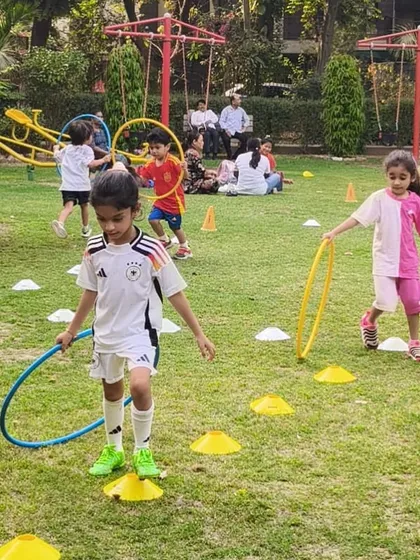 Boys and girls play together, navigating a field of cones and hoops. We foster an inclusive and friendly environment for all our young athletes.