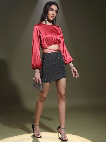 This shot showcases the contrast between the smooth satin top and the sparkling texture of the skirt. It’s a great example of how I mix fabrics to create dynamic party looks.