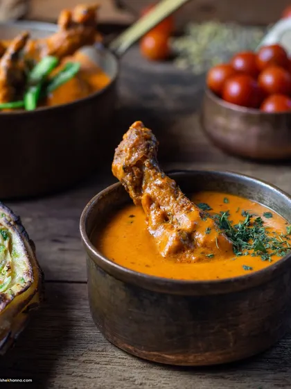 A rustic-styled chicken curry in a traditional bowl, part of my earlier work from 2018, showcasing a consistent quality in Indian food photography.