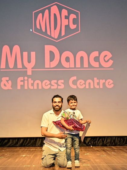Aadil receiving a well-deserved gift for his incredible stage performance.