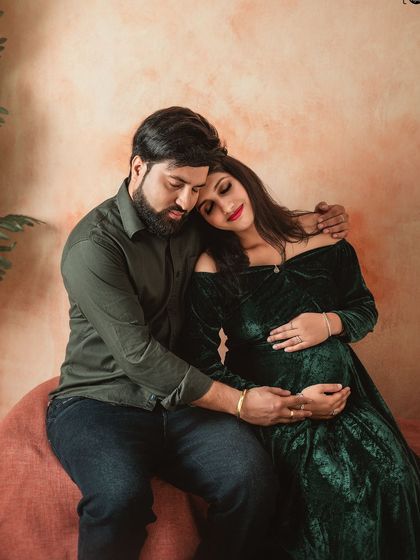 The comfort and safety of a partner's embrace. This moody, warm-toned shot captures the deep emotional connection of a couple awaiting their new arrival.