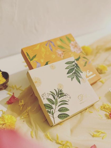 A still life of our elegant festive chocolate boxes, styled with marigold flowers to evoke the spirit of Diwali.