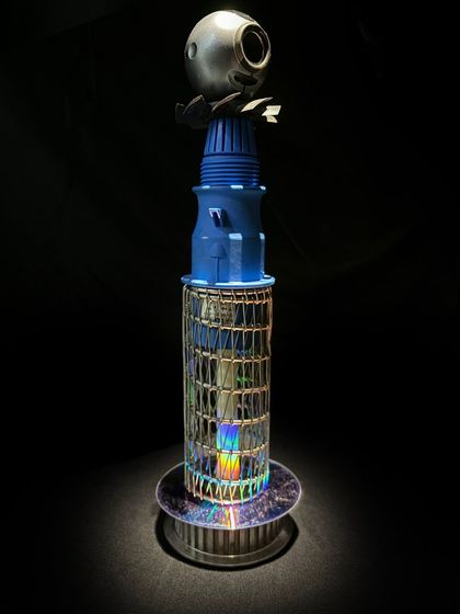 A tower-like award sculpture made from a mix of plastic casings, a webcam, and a CD base. These handcrafted awards are perfect for green events and showcase a commitment to the circular economy.