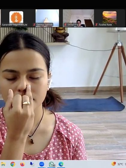 An instructor demonstrates Nadi Shodhana pranayama. This breathing technique is a cornerstone of our stress management workshops, as it effectively balances the nervous system and quiets the mind.