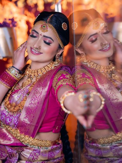 A beautiful moment captured during a Telugu muhurtham demo class. The reflection shows the makeup from another angle, highlighting the flawless finish and the intricate details of the hair and jewellery.