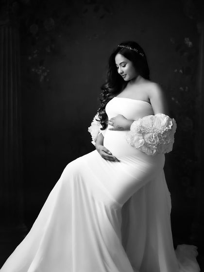 A soft and gentle black and white portrait, focusing on the quiet connection between mama and bump.