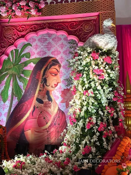 Art and tradition merge in this beautiful decor piece. A floral peacock stands beside a classic Indian painting, creating a corner that is both culturally rich and visually stunning for a wedding celebration.