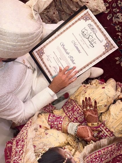 Another shot of the bride signing her Nikah papers. The henna is a beautiful and important part of the ceremony.