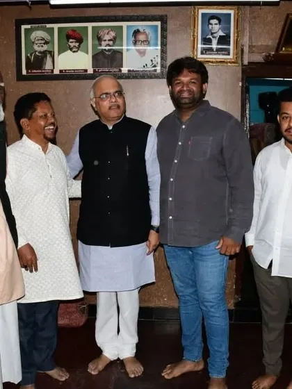 A group photo with Dr. Vinay Sahasrabuddhe and members of our family and artisan community inside our workshop. The portraits on the wall are of our ancestors who started this tradition.