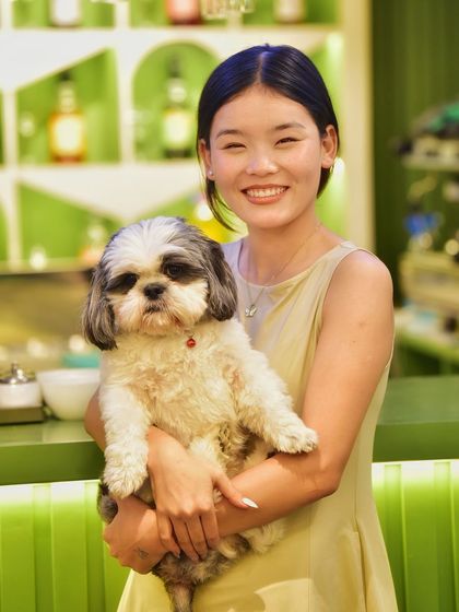 A beautiful portrait of a pet owner and her adorable dog. This shot captures the clear love and connection between them, making for a heartwarming memory.