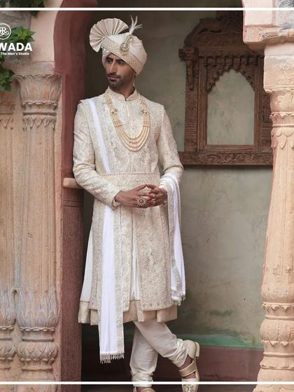 A relaxed yet regal pose, this image showcases the comfort and style of the Shauhar sherwani. It's designed for the groom who wants to enjoy his day without compromising on elegance.