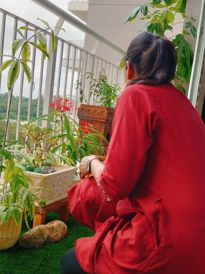 This is my favourite part of any project: adding the finishing touches. Here I am, taking a moment to enjoy the view from a newly completed balcony garden, making sure every plant is perfectly placed before handing it over.