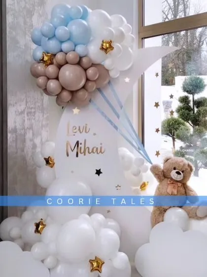 A dreamy, cloud-like baby shower theme. This heavenly setup uses fluffy white balloons to create clouds, a crescent moon backdrop, and a gentle teddy bear accent, perfect for celebrating a little one on the way.
