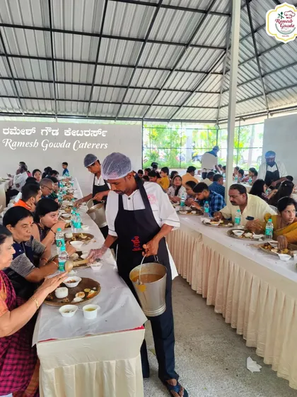 Our service staff is always ready to serve. Here, a team member serves curry during a traditional sit-down lunch, ensuring a personal touch.