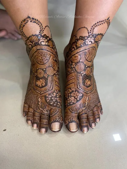 Another angle of the intricate bridal feet design. The patterns are a mix of traditional motifs, creating a timeless and elegant look.