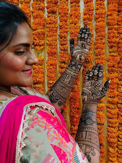 A side profile of Tejashree, her smile and her mehendi both shining bright.