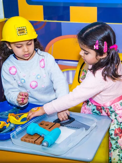 Future engineers at work! These girls are focused on their building project at our pretend play tool bench.