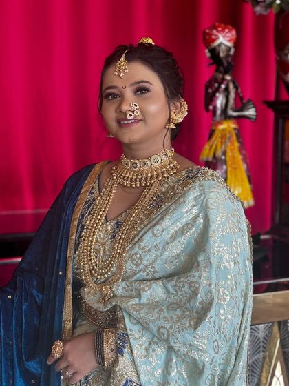 This client chose a lovely pastel blue Nauvari with a blue velvet shela for her event, looking elegant and modern.