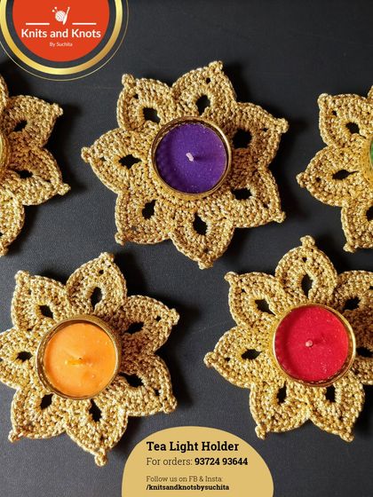 Another look at the golden tea light holders against a dark background, which really makes the gold thread and colorful candles pop.