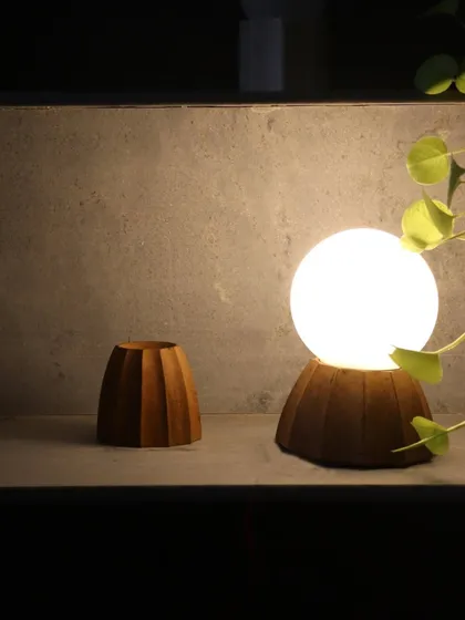 A collection of our custom light fixtures, showing variations in wood and marble bases. Each piece is designed as a small sculpture, contributing to the overall aesthetic and atmosphere of the space.