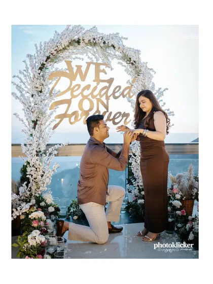 The perfect proposal moment, captured as he gets down on one knee before a beautifully decorated arch that says "We Decided On Forever". We help plan and photograph surprise proposals to make the memory last a lifetime.