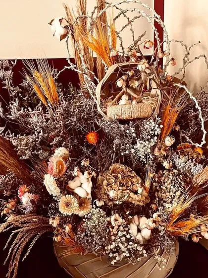 A stunning dried flower arrangement. This long-lasting bouquet features a mix of dried wheat, cotton, and other rustic elements, perfect for home decor or as a unique gift.