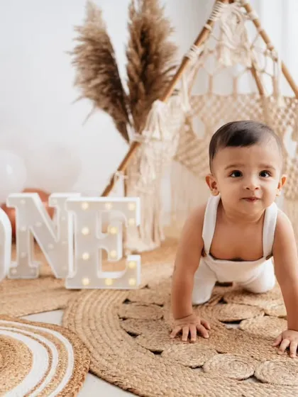 On the move! This crawling shot captures the energy and excitement of a one-year-old exploring the studio during his birthday photoshoot.