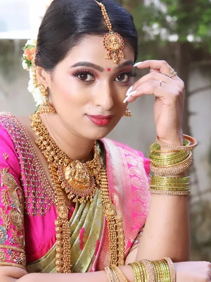 A striking close-up that draws attention to the perfectly blended eye makeup and the traditional temple jewellery.