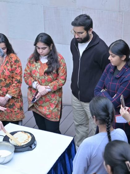 Our director demonstrates how to make crêpes during a French Open Day. Our events often include culinary workshops, offering a delicious taste of French culture.