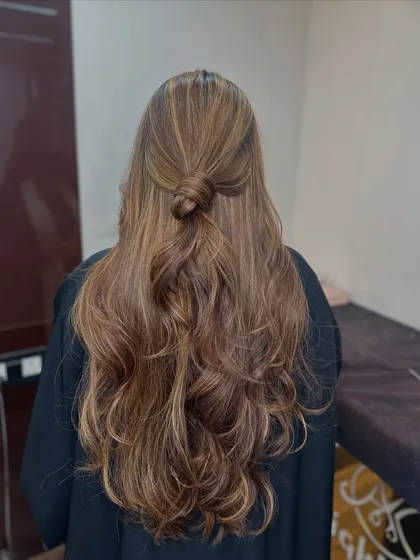 The half knot style perfectly displays the blend of global color and highlights in this honey blonde look.