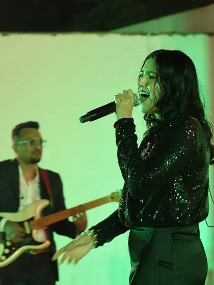 A shot of me singing with our guitarist in the background at a private event. The chemistry within the band ensures a tight, professional performance.