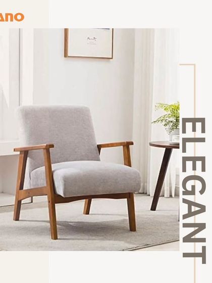 An elegant armchair with a solid wood frame and light grey upholstery. This piece blends mid-century modern design with timeless comfort, making it suitable for various interior styles.