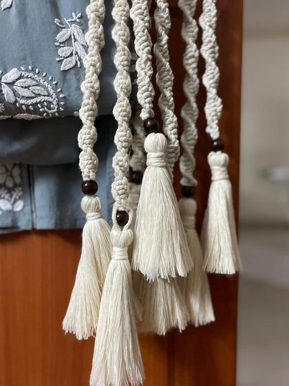 These are my handmade macrame curtain tie-backs. They are made with natural cotton cord, wooden beads, and have lovely tassels. It's a simple way to add a touch of boho style to your curtains.