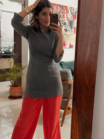Don't label your clothes, style them. Here I've paired bright red trousers with a simple grey short kurta for a unique, contemporary ethnic look.