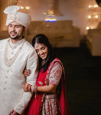 A quiet, candid moment between the couple. The bride resting her head on the groom's arm shows their comfort and deep connection.