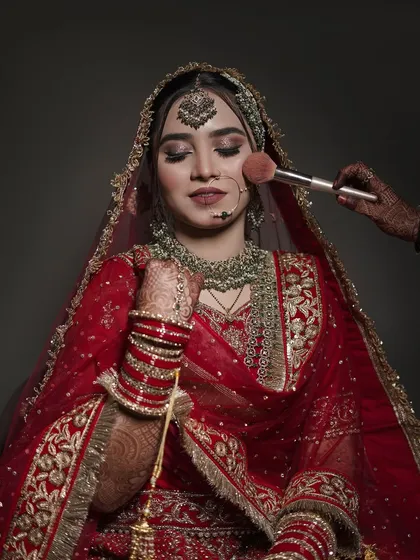 A professional shot capturing the moment I apply blush. It highlights the collaborative and gentle process of getting ready.