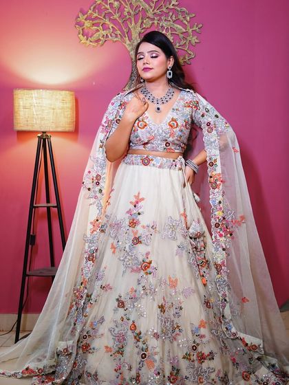 A full-length shot that showcases the modern elegance of this white floral lehenga.