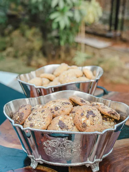 Bowls of freshly baked chocolate chip cookies and butter cookies, a simple and comforting treat for any high tea.