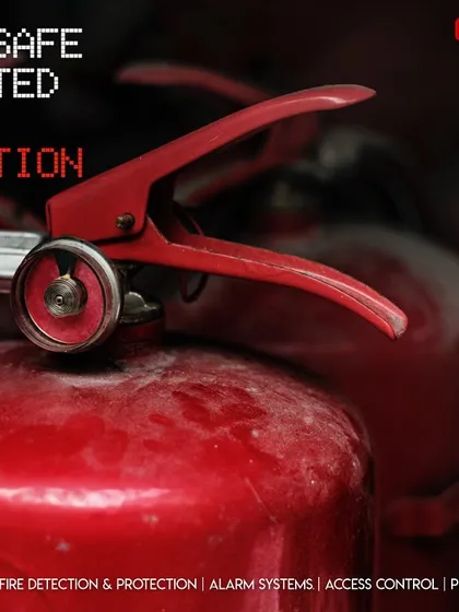 A close-up view of a fire extinguisher handle and pressure gauge. We emphasize the importance of regular inspections to ensure that every piece of fire safety equipment is charged and ready for an emergency.