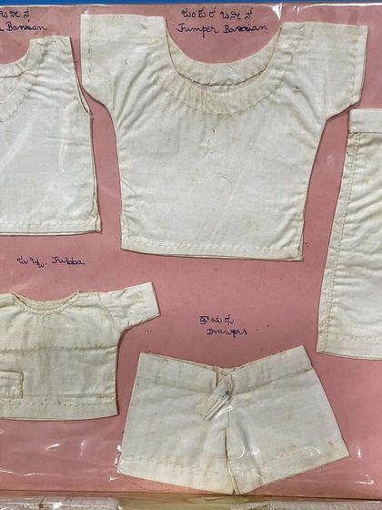 A collection of miniature white garments from the 1963 journal, including a 'jubba' and 'knickers'. This shows the breadth of her tailoring education.