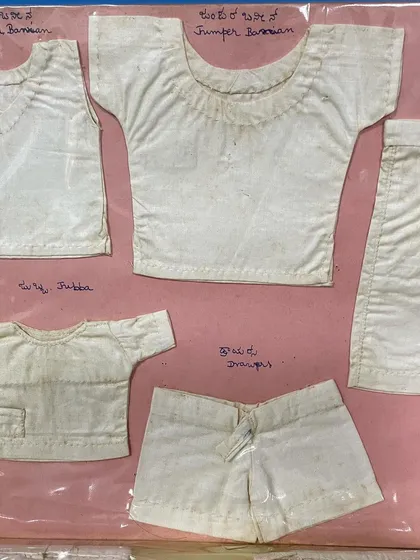 A collection of miniature traditional Indian garments like the 'jubba' and 'knickers' from my mother's journal. Her attention to detail was remarkable.