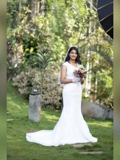 Wilsy, radiant and confident on her wedding day. The mermaid silhouette with its long train looks absolutely stunning in this beautiful garden setting.