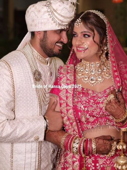 A happy couple on their wedding day. Their smiles are infectious, and the bride's mehendi is a beautiful symbol of their union and shared joy.