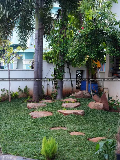 In this shady garden, I used large, irregular flagstones to create a rustic path through a dense groundcover, nestled between mature palm trees.
