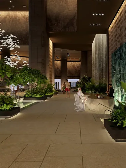 The pool area at Palais Royale, where a crystalline ribbon of water is surrounded by lush greenery and comfortable lounge seating. The design creates a refined Tropicana vibe in the heart of the city.