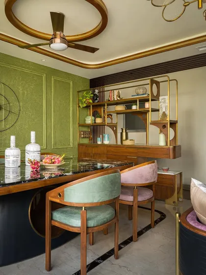The dining space, featuring Victorian-inspired molding, a rustic olive concrete texture, and an experimental dining table.