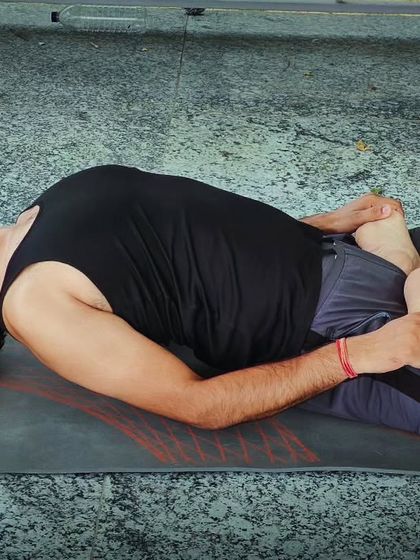 This is Matsyasana, or Fish Pose, which fully extends the dorsal region and opens the chest. I teach this pose to improve breathing capacity and stimulate the thyroid gland.